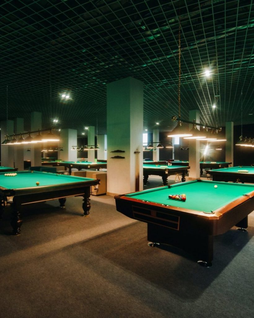 Billiard table with green surface and balls in the billiard club.Pool Game