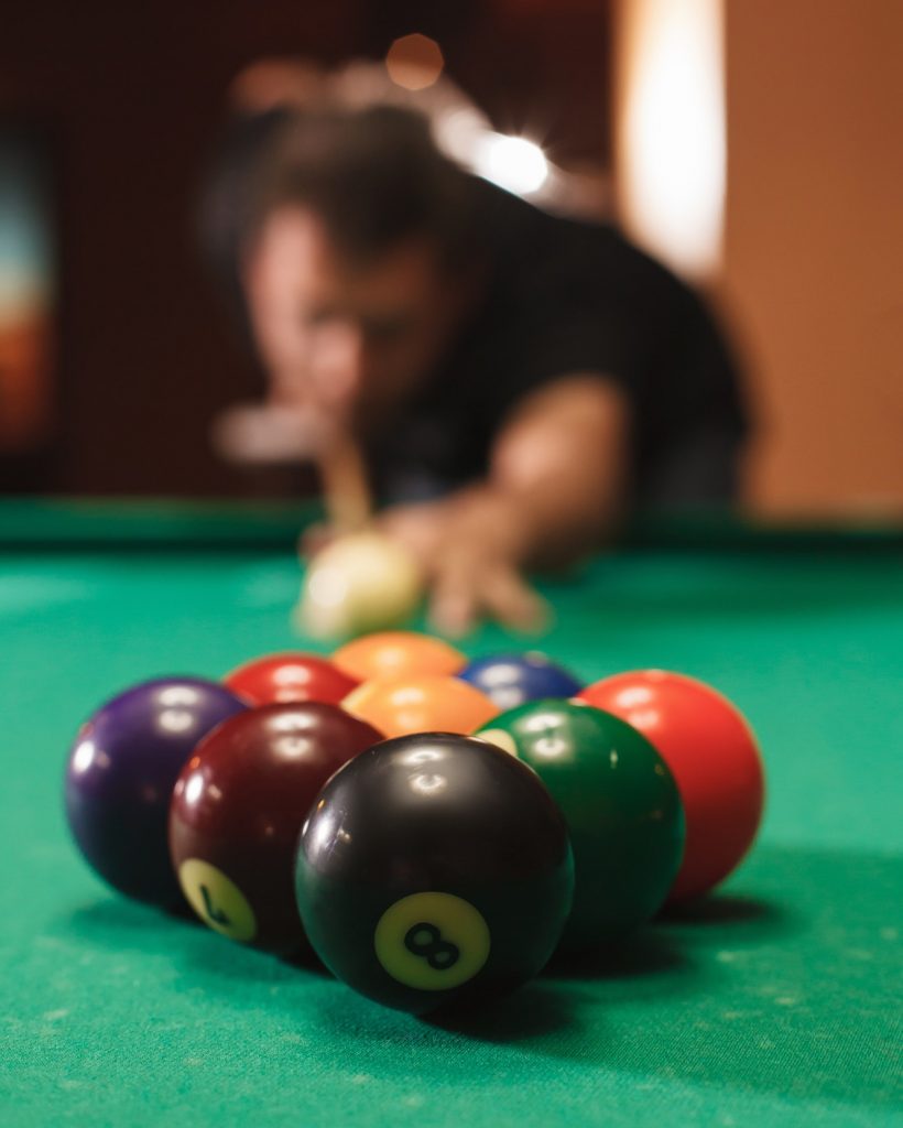 Player breaks a pyramid in billiards.